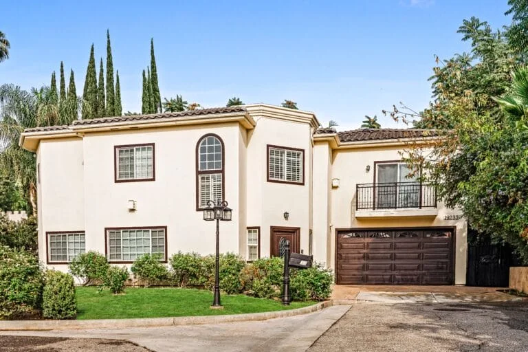 Cream residential building and driveway pictured by Sanctuary